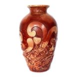 A Bretby Art Pottery large vase with sang de boeuf glaze decoration on moulded fish and wave motifs,