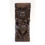 An Elizabethan small oak capital, carved in high relief with a stylised figure resembling Queen