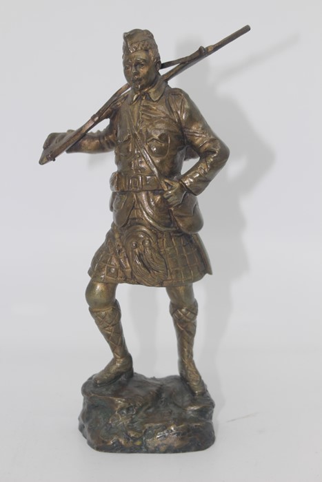 Georges Omerth (act.1895-1925), a bronze study of a WWI Scottish Soldier holding a rifle over his