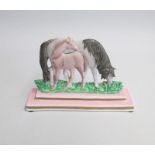 A Porcelain Horse and Pony group on a pink stepped base, Probably Swansea. Flat backed  Date: