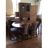 A traditional oak dining room suite, comprising an oak side cabinet, an extending dining table,