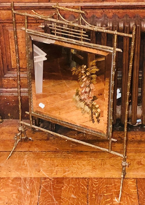 An Edwardian brass bamboo design firescreen, mirror glassed inlay with floral decoration. 77cm H x