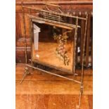 An Edwardian brass bamboo design firescreen, mirror glassed inlay with floral decoration. 77cm H x