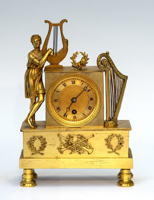 A 19th Century gilt metal boudoir timepiece of Empire design, surmounted with a classical maiden