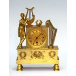 A 19th Century gilt metal boudoir timepiece of Empire design, surmounted with a classical maiden