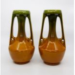 A pair of Bretby Art Pottery Arts & Crafts twin handled vases, green and ochre glazes, No.565C,