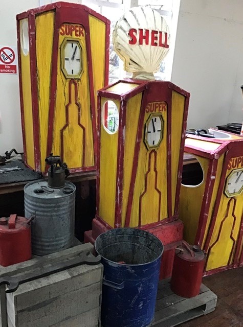 Garage scene comprising Petrol pumps, one with Shell Globe  (plastic) oil drums, tools etc. Pumps