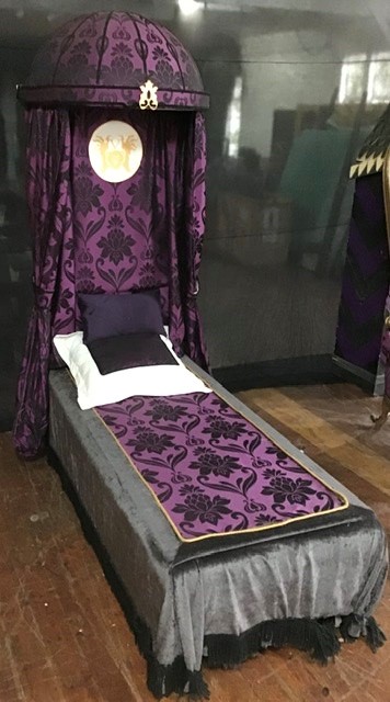 The Baroness’s Bed including pillows, teddy bears. bed approximately 7 feet long and 30 inches wide.