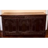 An Elizabethan oak plank chest, circa 1560, hinged rectangular top above three panel front carved in