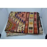 A Turkish hand made woollen rug, from Slimak, with geometric design on a red and cream background,