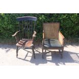 An early 20th Century oak canework bergere chair and a 19th Century kitchen Windsor chair (2)