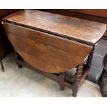 An early 18th Century joined oak gateleg table, having a two plank top, the leaves each formed of