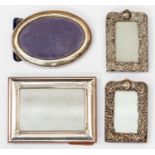 A pair of George V silver mounted photo picture frames, chased with profuse scrolling decorations,