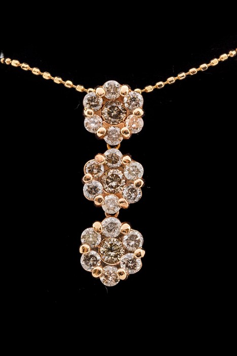 A champagne diamond and 9ct rose gold cluster necklace, comprising three hinged floral details - Image 2 of 2