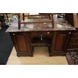 A late 19th Century mahogany and marble topped kneehole desk, the red marble top raised on a base