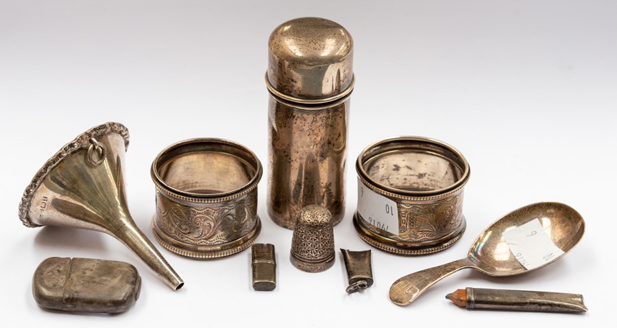 A group of silver including: two various napkin rings; small wine funnel; caddy spoon; vesta case,
