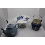 A Wedgwood blue and white cake stand decorated with shells and foliage, incised mark to base