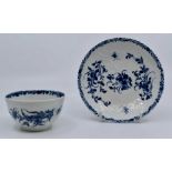A Worcester First or Dr. Wall period tea bowl and saucer, decorated decorated in underglaze blue and