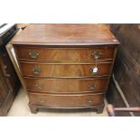 A George III style mahogany bow fronted chest of drawers, late 20th Century, comprising four long