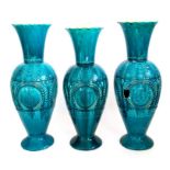 A large near pair of Bretby Art Pottery baluster vases, turquoise glazes and moulded decoration of