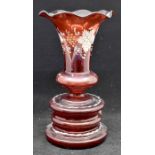 A late nineteenth century cranberry glass vase with flared rim and floral decoration. Pontil mark to