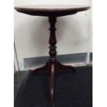 A late 18th Century tilt top oak tripod table, the circular top raised on a turned column, 70cm