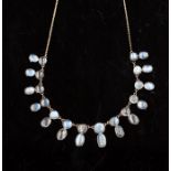 A Victorian moonstone fringe necklace, set to the front with fourteen cabochon moonstones, double