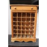 A 20th Century solid pine wine rack, having a single drawer to top and 30 bottle spaces, 82cm