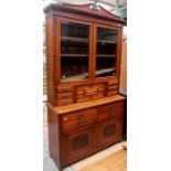 A late Victorian Aesthetic walnut bookcase, circa 1885, the upper section with two bevel edged