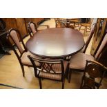 A contemporary mahogany effect dining suite, comprising a dining table and a set of four chairs,