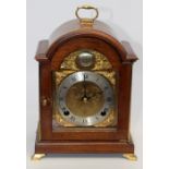 An Elliott eight day mahogany cased mantle clock, arched case, silvered chapter dial, reading '
