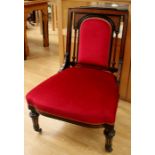 A mid Victorian Aesthetic ebonised and veneered ladies chair, upholstered in crimson red, padded