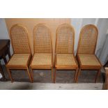 A set of four contemporary oak dining chairs, of recent manufacture, having canework inset seats and