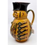 A 20th Century Hungarian fruit wine pitcher, painted under glaze, signed underside, red earthenware,