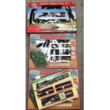 Four battery operated train sets, boxed.