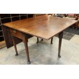 A George II oak drop leaf table, fitted with a single drawer, raised on off-centre turned legs,