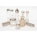 A collection of assorted early 20th Century silver capped scent bottles, vases, dressing table