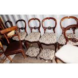 A set of five Victorian walnut balloon back chairs, four having matching upholstery, all raised on