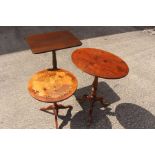 Two 19th Century tilt-top tripod tables, one with an oval top; the other with a rectangular top,