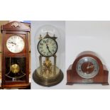 A George V eight day wall clock, 1950's mantle clock with silvered dial and a German anniversary