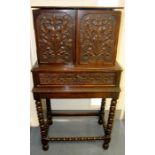 A 19th Century collectors cabinet on stand, the two doors enclosing multiple drawers and a central