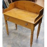 A Victorian pine washstand, splash back, fitted with a single drawer, raised on turned legs, 100cm