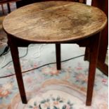 A George III oak cricket table, circa 1810, the circular top raised on three square legs, 72cm high,
