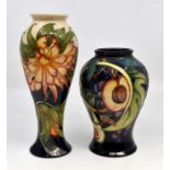 A Moorcroft pedestal baluster vase decorated with peaches, figs and grapes, designed by Emma Bossons