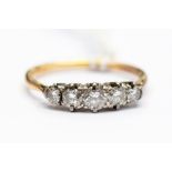A diamond and 18ct gold five stone ring, the centre diamond weighing approx. 0.20ct, size P, total