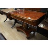 A mid Victorian mahogany fold over card table, the upper section raised on an octagonal baluster