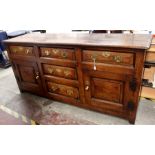 A George III joined oak dresser base, circa 1770, the front with raised and fielded door panels