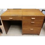 A mid 20th Century oak desk, the left side lifting up and revealing a writing surface, the right
