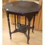 An Edwardian ebonised octagonal occasional table, of two-tier form, 70cm high, 60cm in diameter
