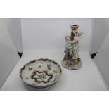 A German porcelain figural candlestick, in the form of a young gentleman proposing to a young